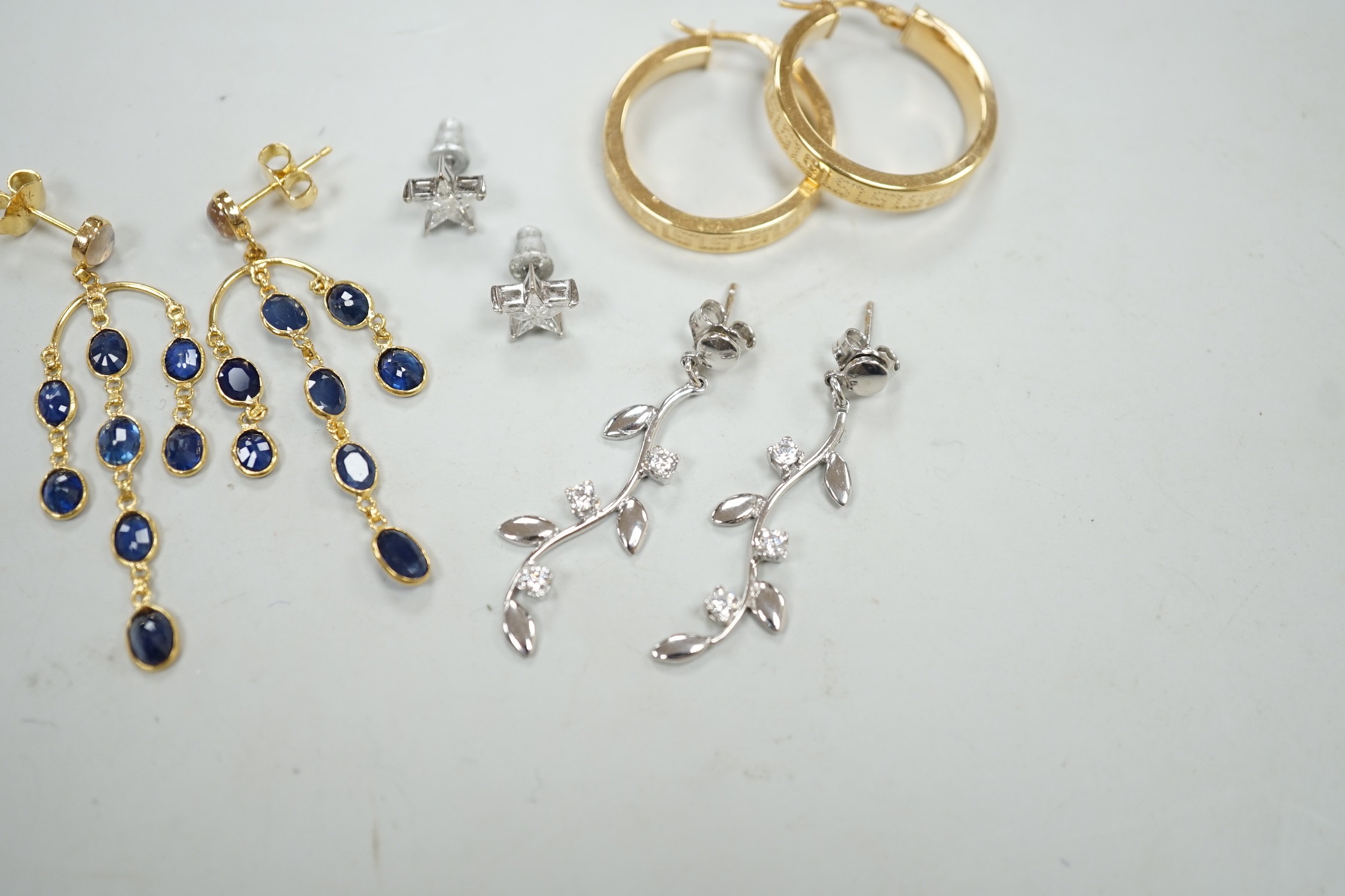 A modern pair of 18ct white gold and diamond cluster set star ear studs, 8mm, gross weight 1.1 grams, a similar pair of 14k, moonstone and sapphire cluster drop earrings, gross 3.5 grams and two pairs of 9ct earrings, gr